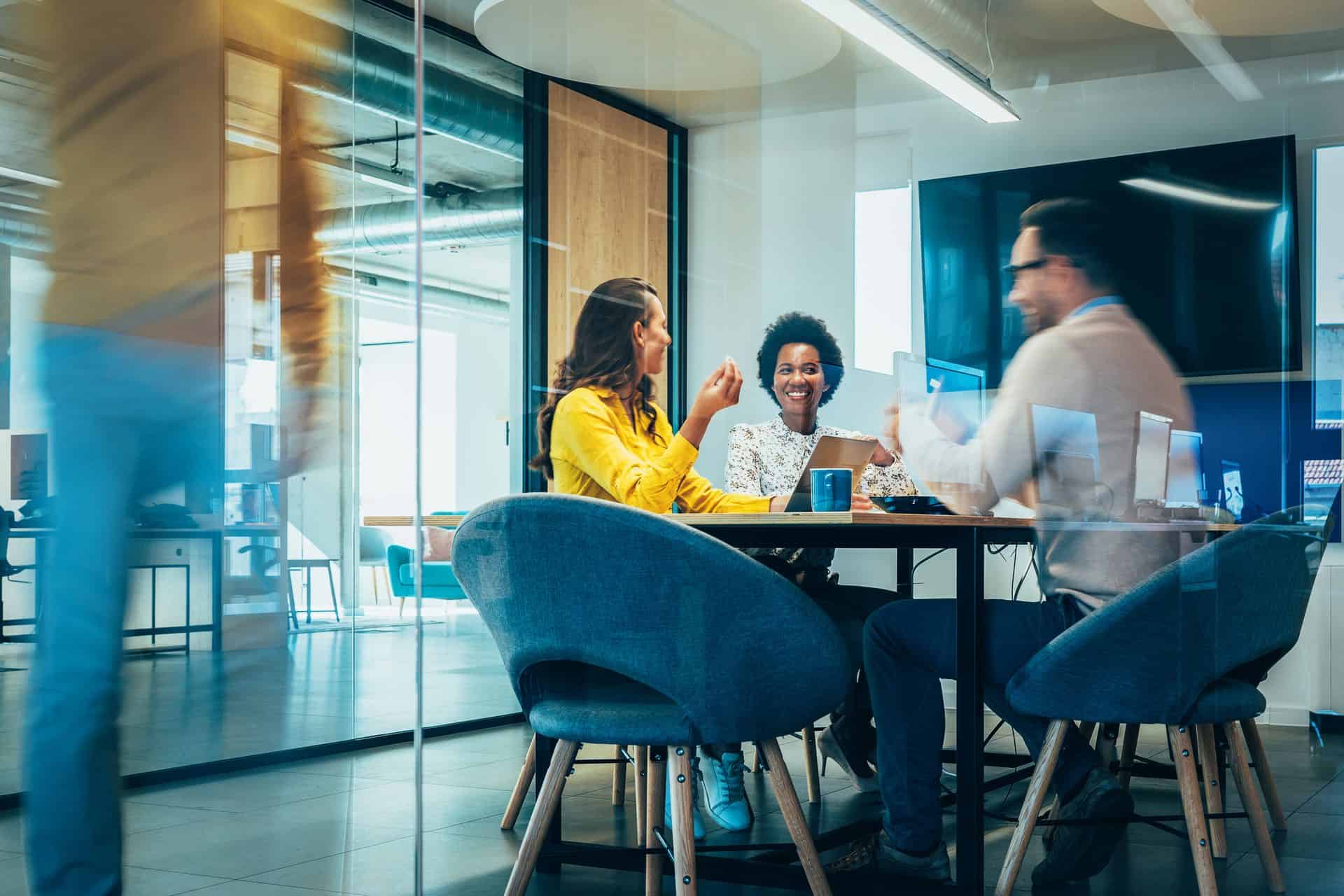 Business team discussing strategies in modern office conference room.